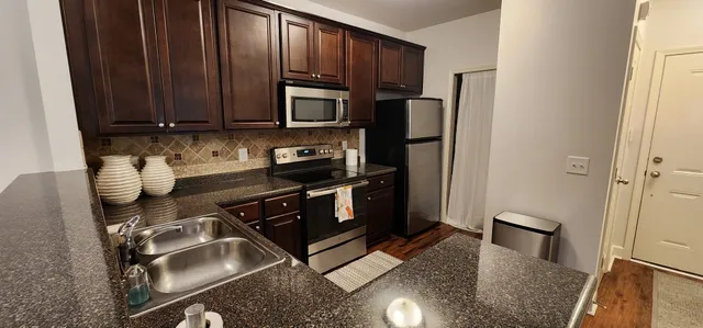 a kitchen with a refrigerator stove and sink