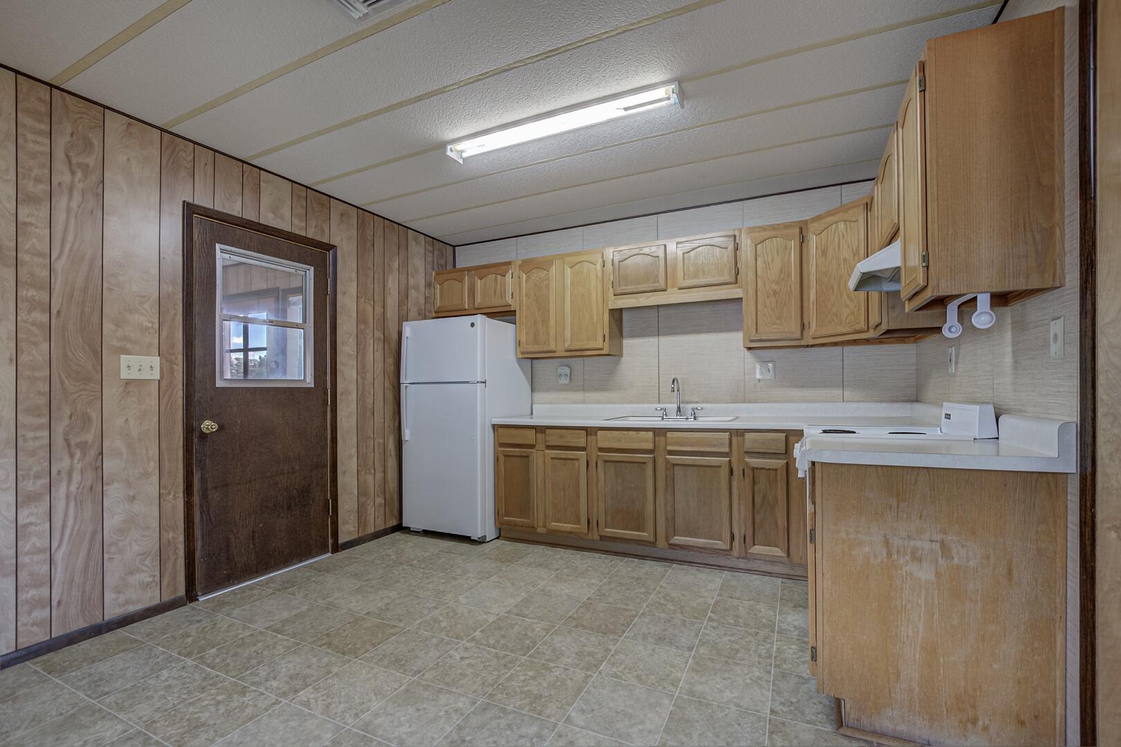 411 West Bridle Path Lane Payson, AZ 85541 - Photo 11 of 21 a kitchen with a refrigerator sink and cabinets