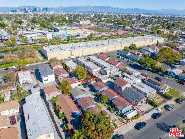 an aerial view of a houses with yard