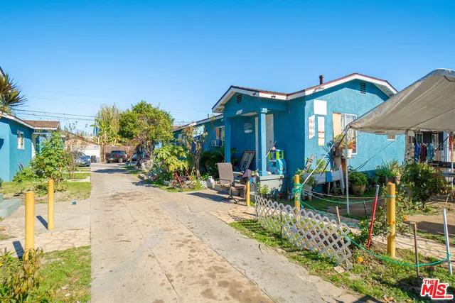 a backyard of a house with yard and outdoor seating