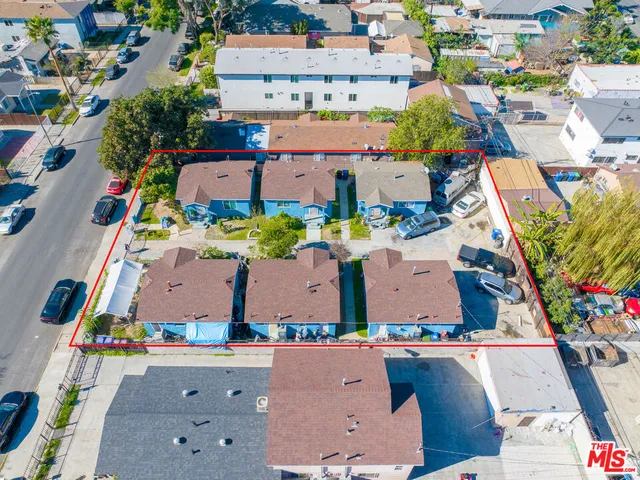 an aerial view of multiple houses with yard