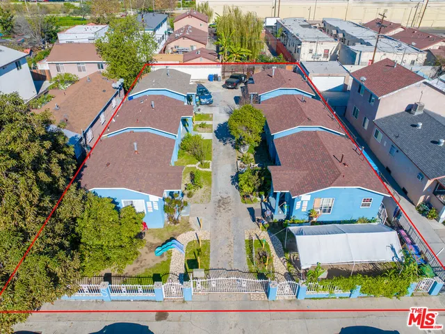 an aerial view of residential houses with outdoor space