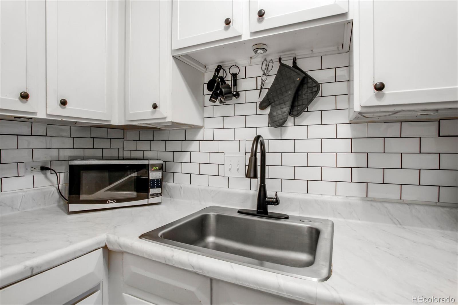 830 20th Street, Unit 304 Boulder, CO 80302 - Photo 11 of 25 a kitchen with a sink and cabinets