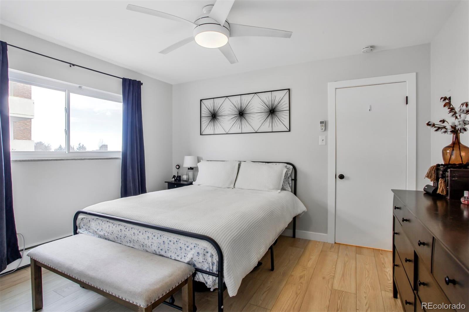 830 20th Street, Unit 304 Boulder, CO 80302 - Photo 13 of 25 a bedroom with a bed and wooden floor