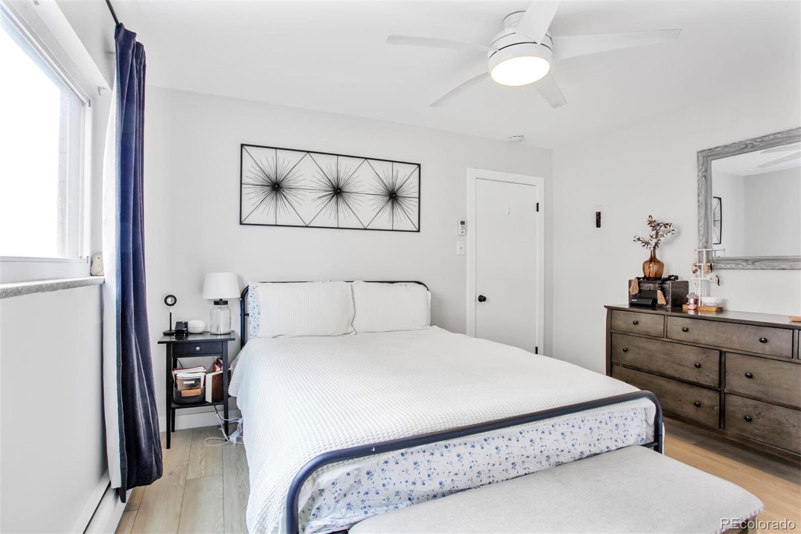 830 20th Street, Unit 304 Boulder, CO 80302 - Photo 14 of 25 a bedroom with a bed and a dresser
