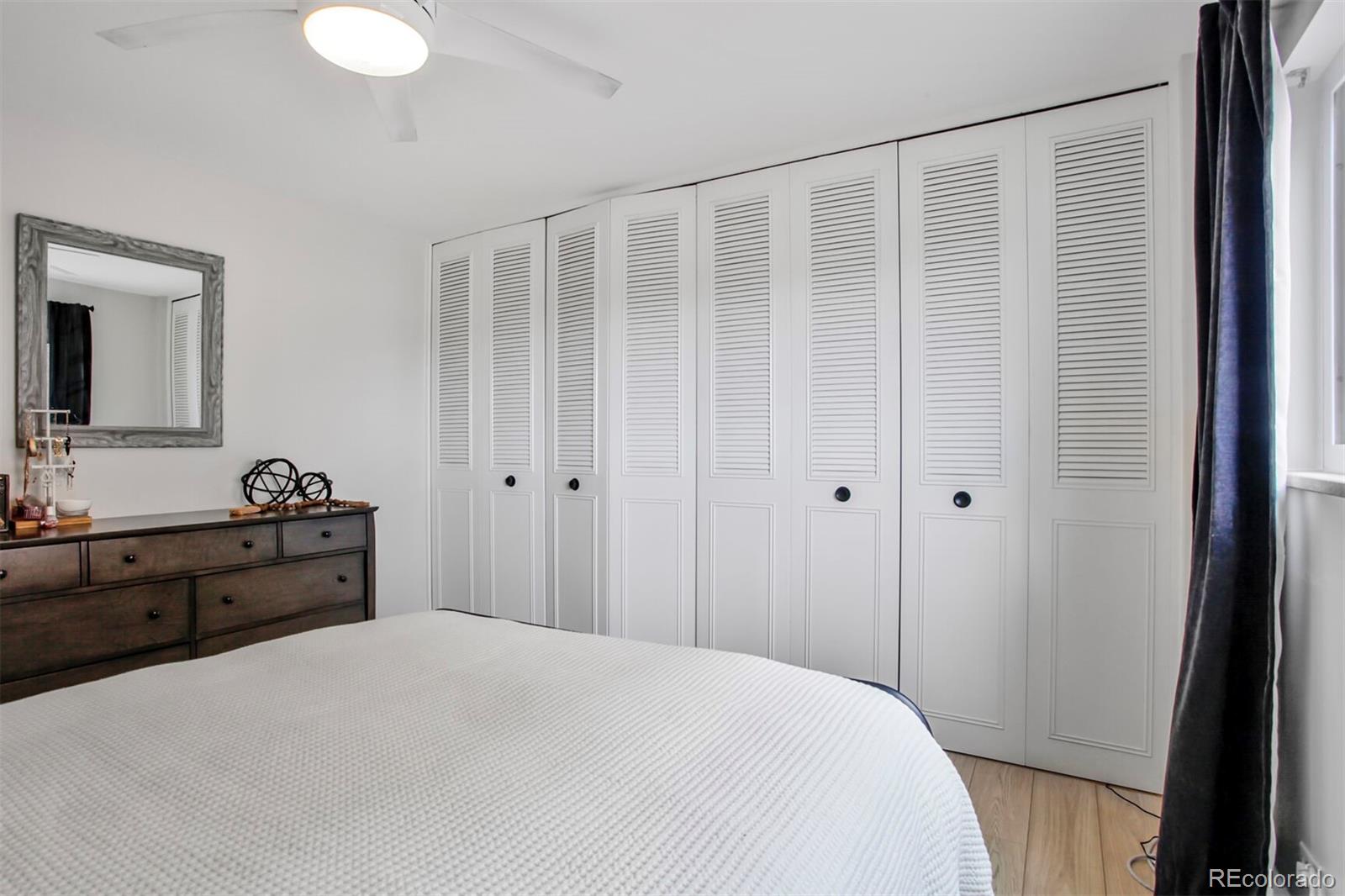 830 20th Street, Unit 304 Boulder, CO 80302 - Photo 15 of 25 a large bedroom with a bed and a dresser