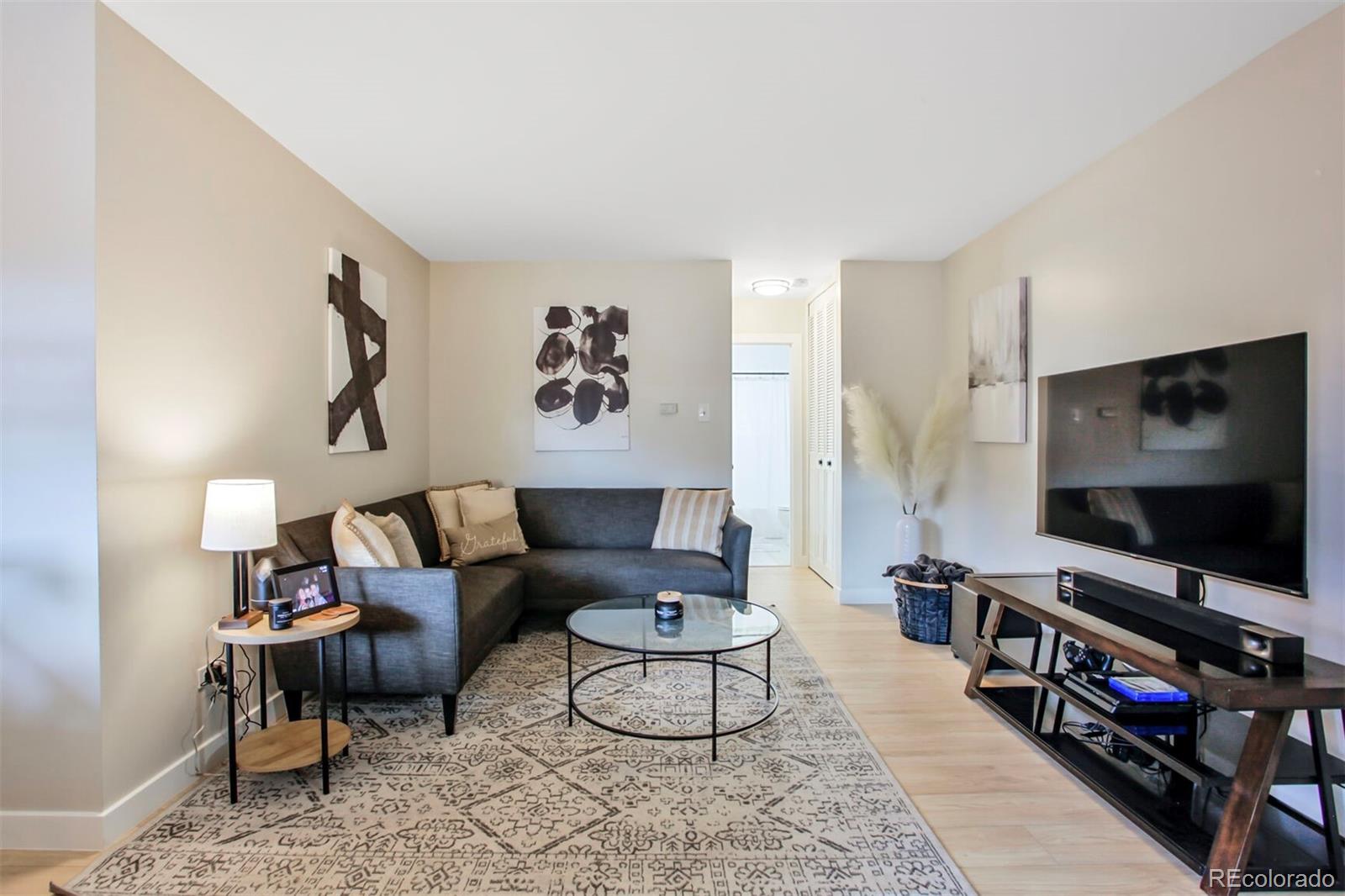 830 20th Street, Unit 304 Boulder, CO 80302 - Photo 2 of 25 a living room with furniture and a flat screen tv