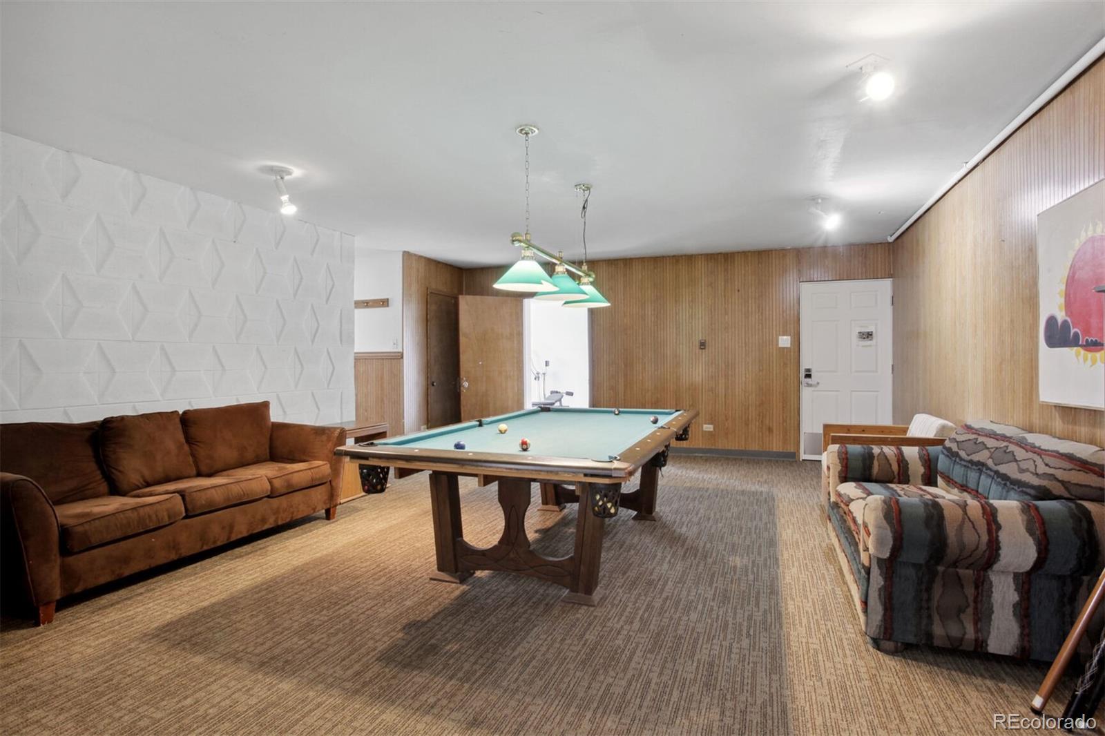830 20th Street, Unit 304 Boulder, CO 80302 - Photo 21 of 25 a living room with furniture a table and a chandelier