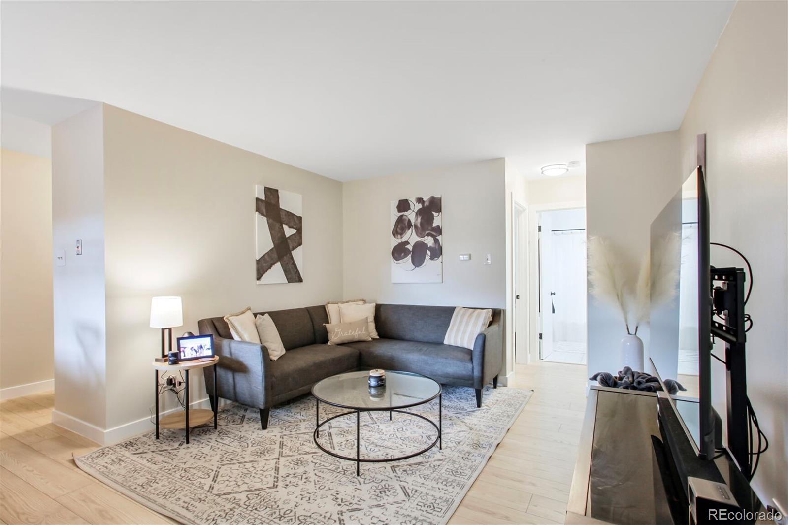 830 20th Street, Unit 304 Boulder, CO 80302 - Photo 3 of 25 a living room with furniture and a flat screen tv