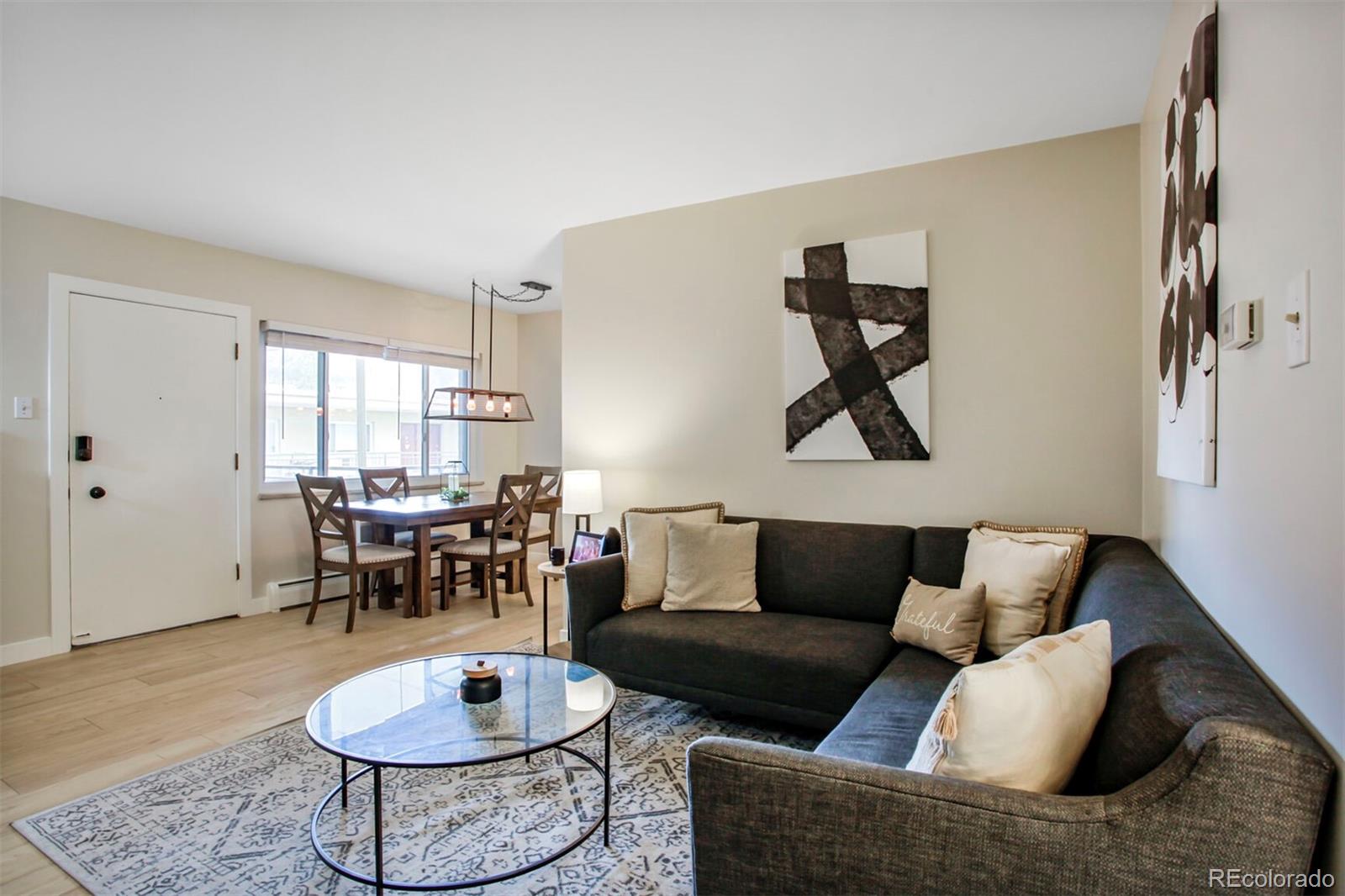 830 20th Street, Unit 304 Boulder, CO 80302 - Photo 4 of 25 a living room with furniture and a wooden floor