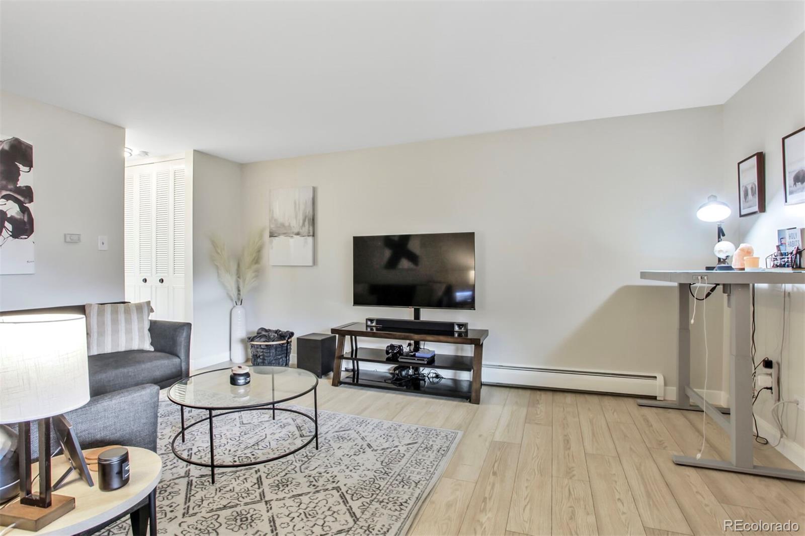 830 20th Street, Unit 304 Boulder, CO 80302 - Photo 5 of 25 a living room with furniture and a flat screen tv