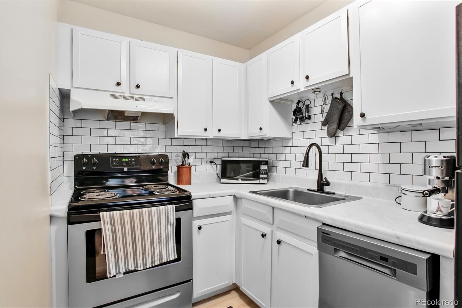 830 20th Street, Unit 304 Boulder, CO 80302 - Photo 10 of 25 a kitchen with cabinets appliances and a sink