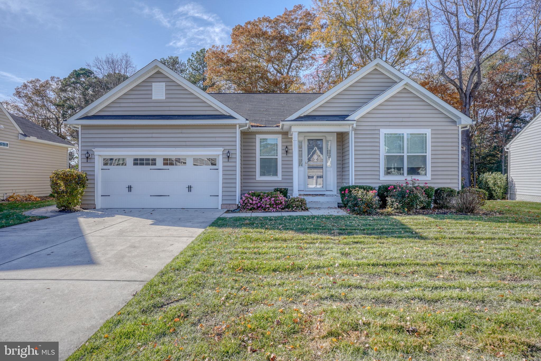 34273 Spring Brook Avenue Lewes, DE 19958 - Photo 1 of 73 a front view of a house with garden