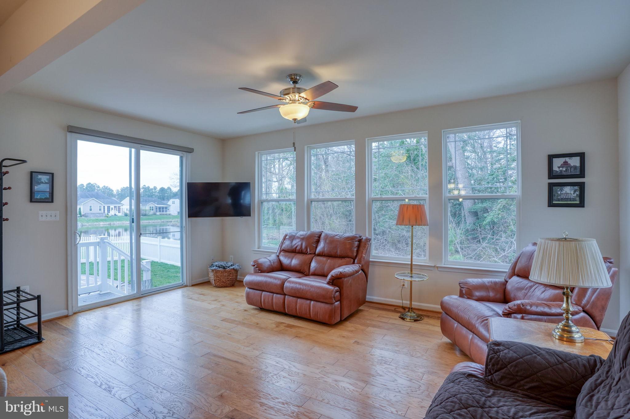34273 Spring Brook Avenue Lewes, DE 19958 - Photo 22 of 73 a living room with furniture and a large window