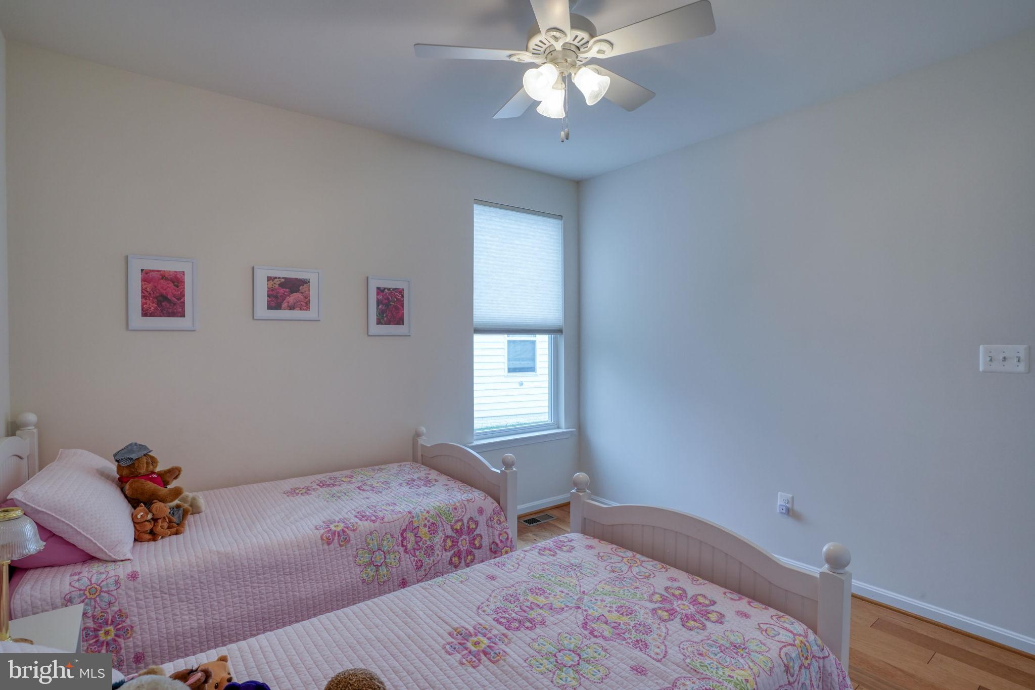 34273 Spring Brook Avenue Lewes, DE 19958 - Photo 33 of 73 a bedroom with a bed and a chandelier