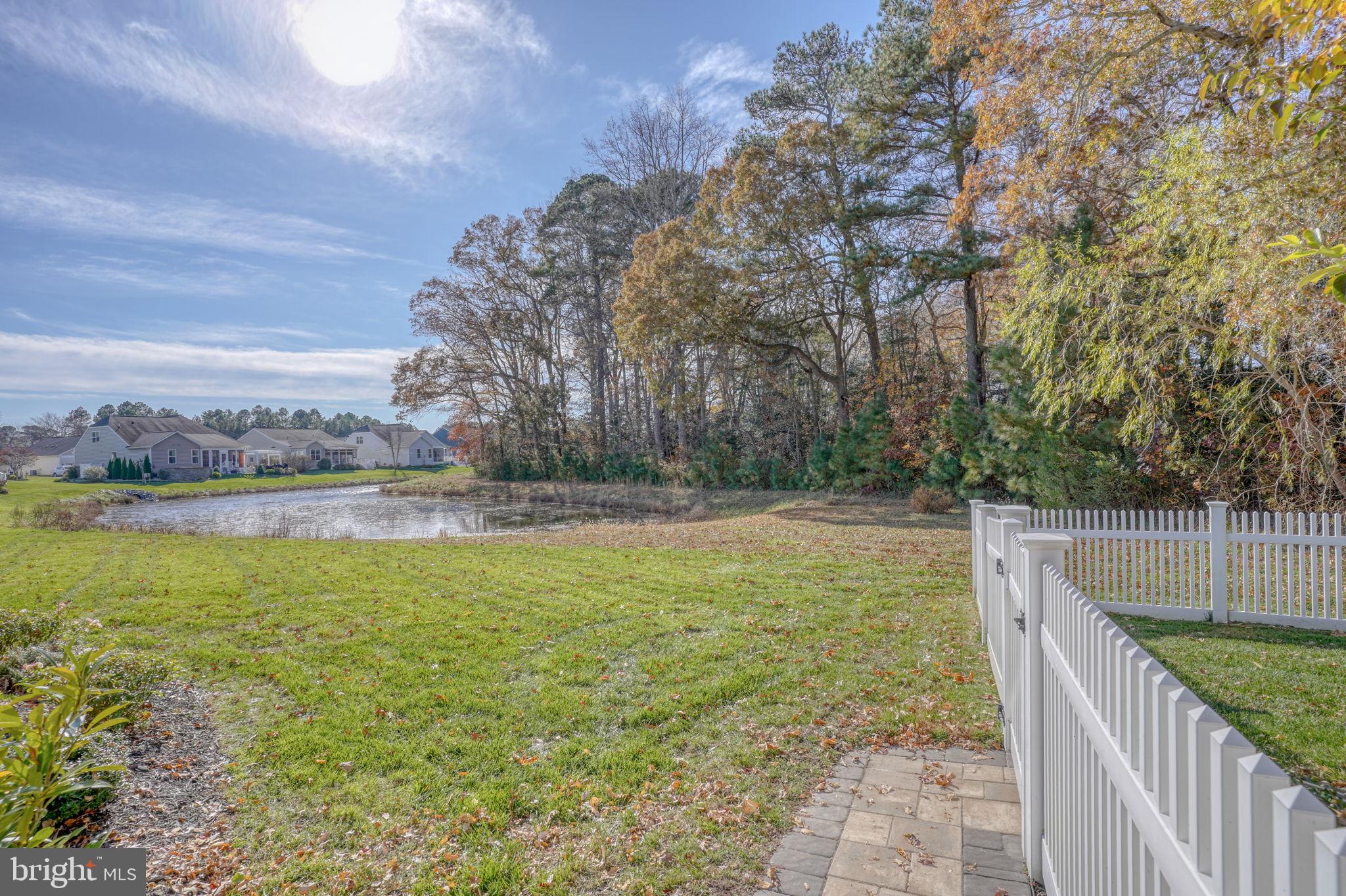 34273 Spring Brook Avenue Lewes, DE 19958 - Photo 39 of 73 a view of a lake with a yard