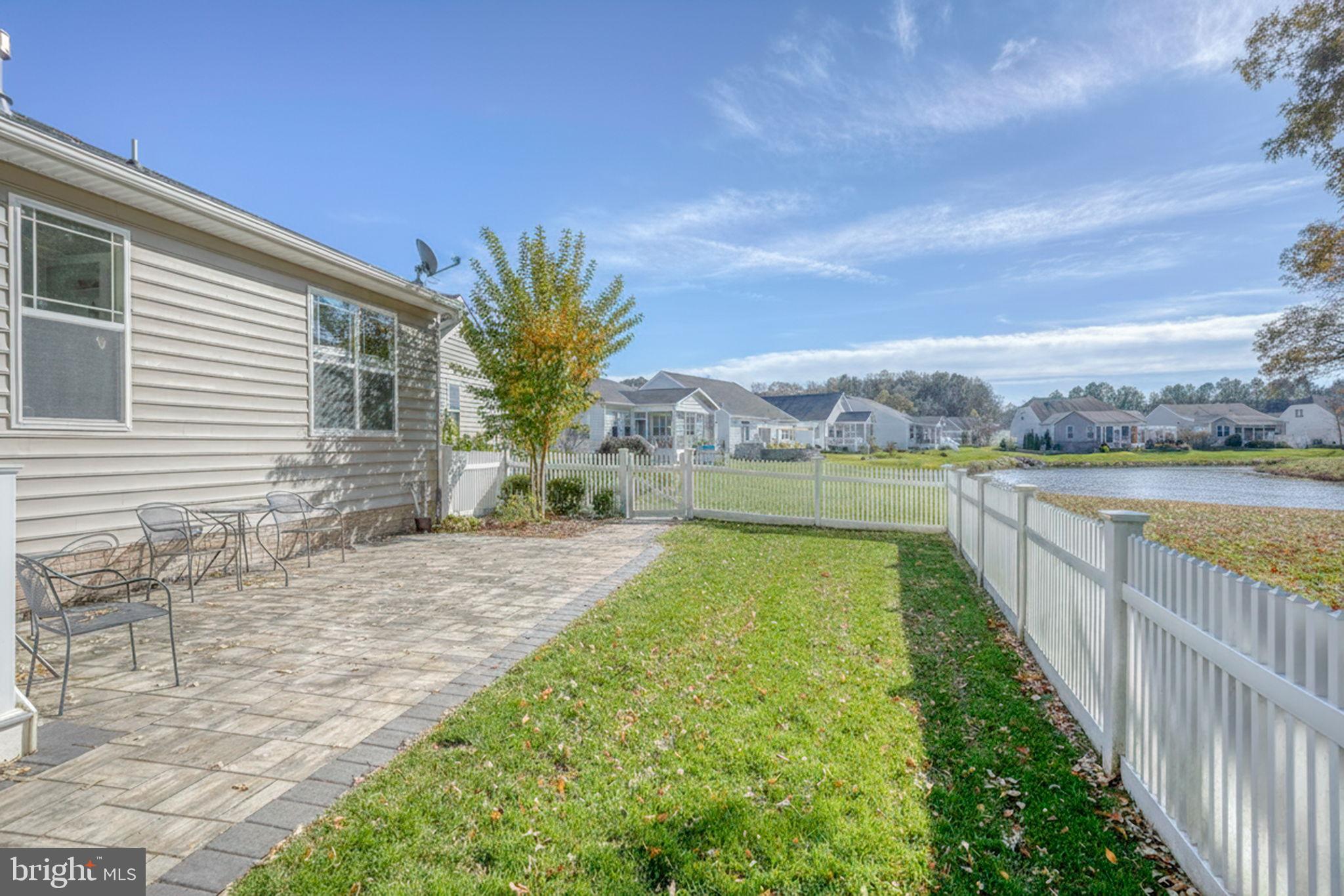 34273 Spring Brook Avenue Lewes, DE 19958 - Photo 4 of 73 a view of a house with a swimming pool and a yard