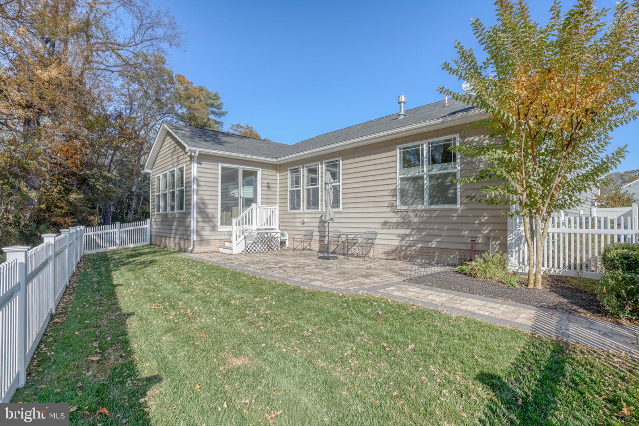 34273 Spring Brook Avenue Lewes, DE 19958 - Photo 5 of 73 a front view of a house with garden