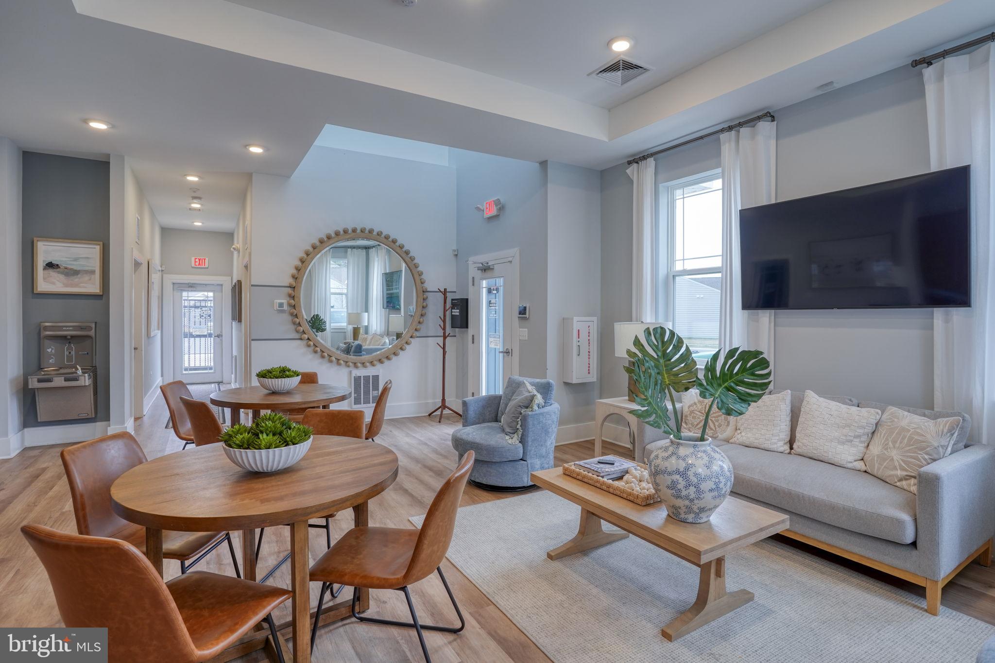 34273 Spring Brook Avenue Lewes, DE 19958 - Photo 67 of 73 a living room with furniture a flat screen tv and a large window