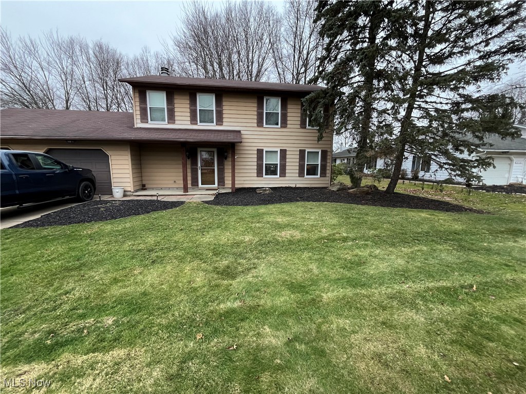 1455 Welch Road Painesville, OH 44077 - Photo 1 of 42 Traditional-style house with an attached garage and a front lawn