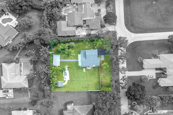 an aerial view of a house with a yard