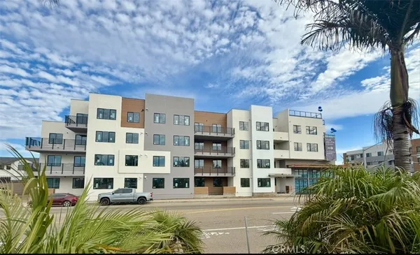a front view of a building with a garden