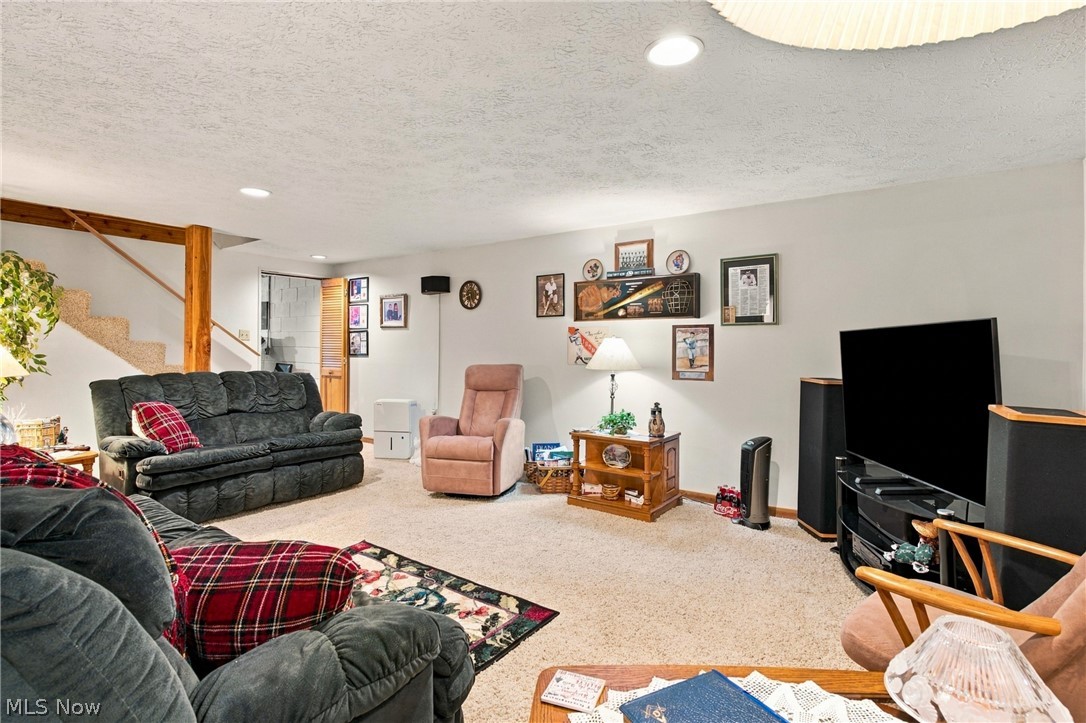 1211 Etter Road Mogadore, OH 44260 - Photo 33 of 48 Recessed lighting illuminates a spacious room with light-toned carpeting and neutral wall colors