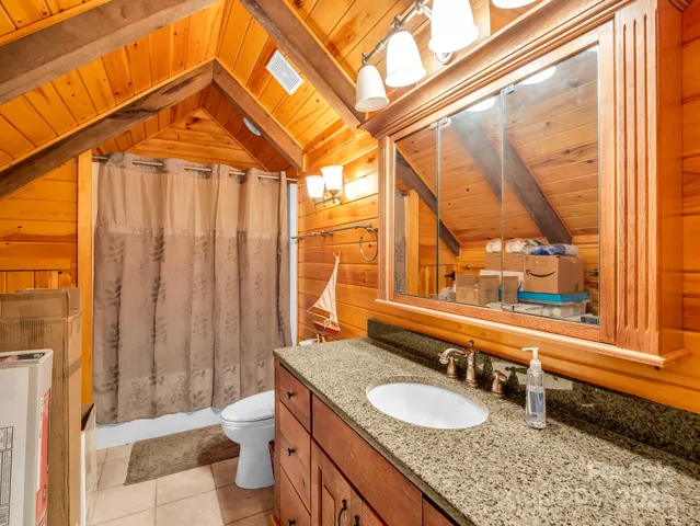 a view of a wooden deck with a trees in the background