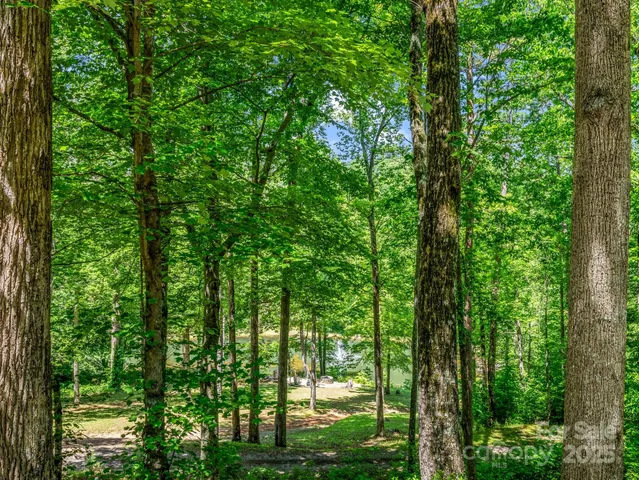 a view of house with swimming pool and sitting area