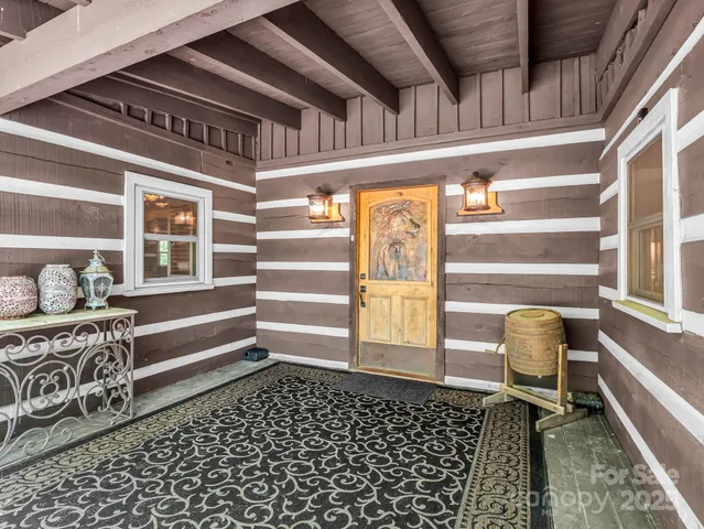 a living room with furniture a fireplace and wooden floor