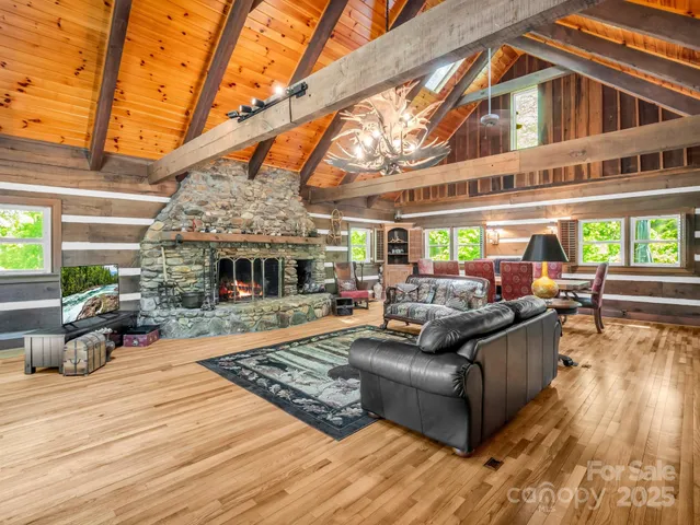a view of a patio with couches table and chairs with wooden floor and fence