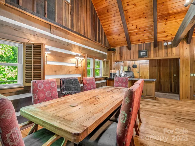 a kitchen with stainless steel appliances granite countertop a sink a stove and a wooden cabinets