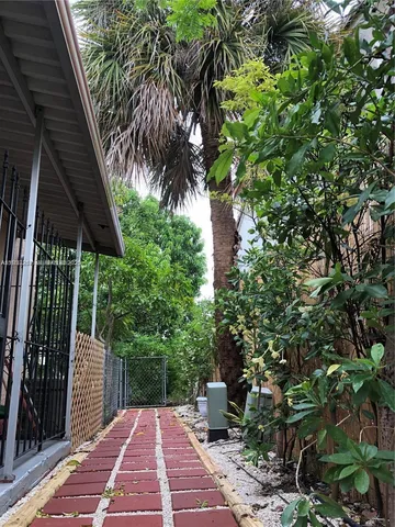 a view of backyard with plants and outdoor seating