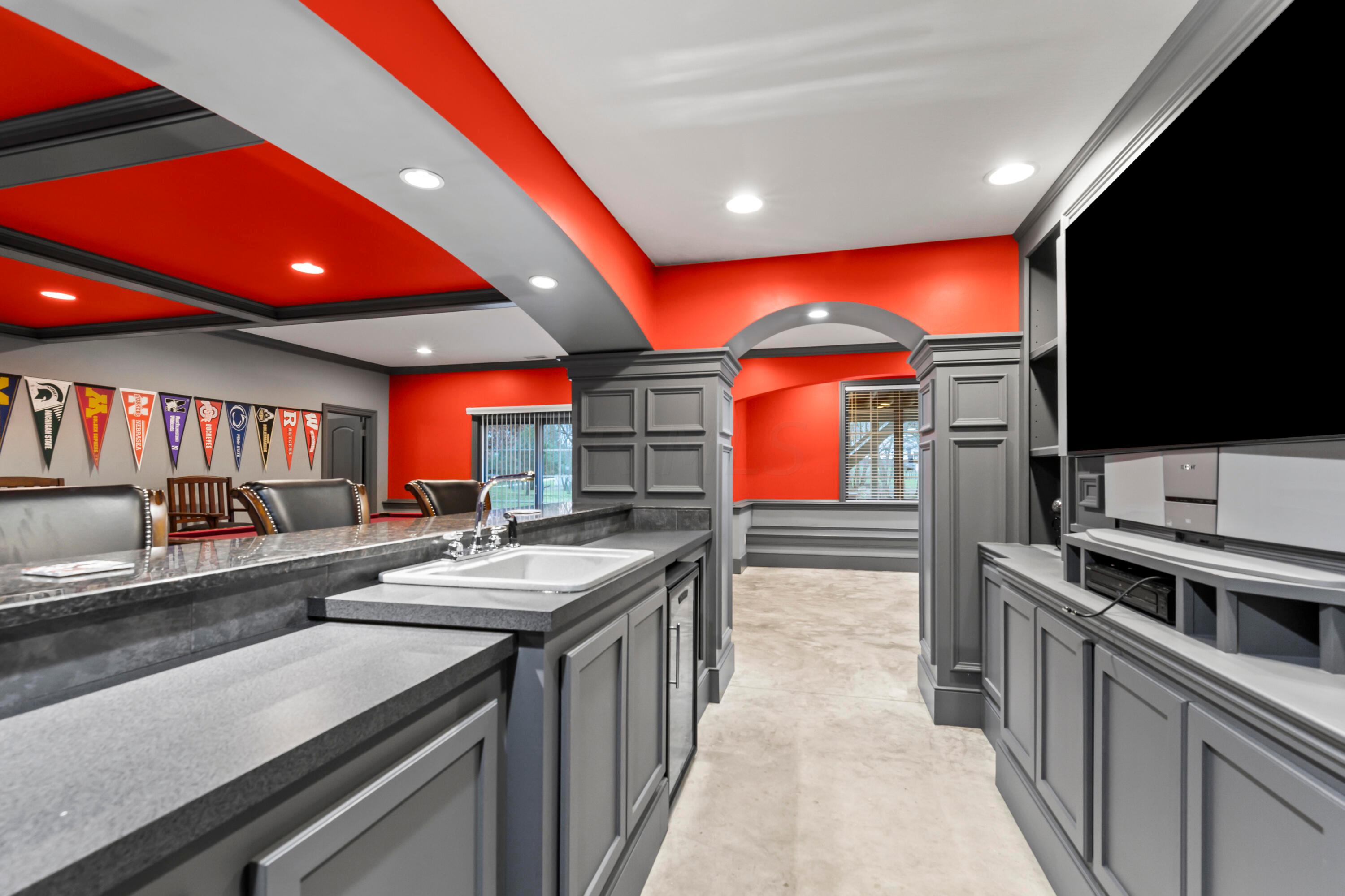 6043 Dublin Road Delaware, OH 43015 - Photo 54 of 98 • Concrete flooring
• Scarlet & grey painted walls
• Can lighting
• Beverage center remains
• Built-in entertainment
center
• Built-in shelves
• Closet under stairs
• Laminate countertop
• Granite bar ledge
• Single bowl sink