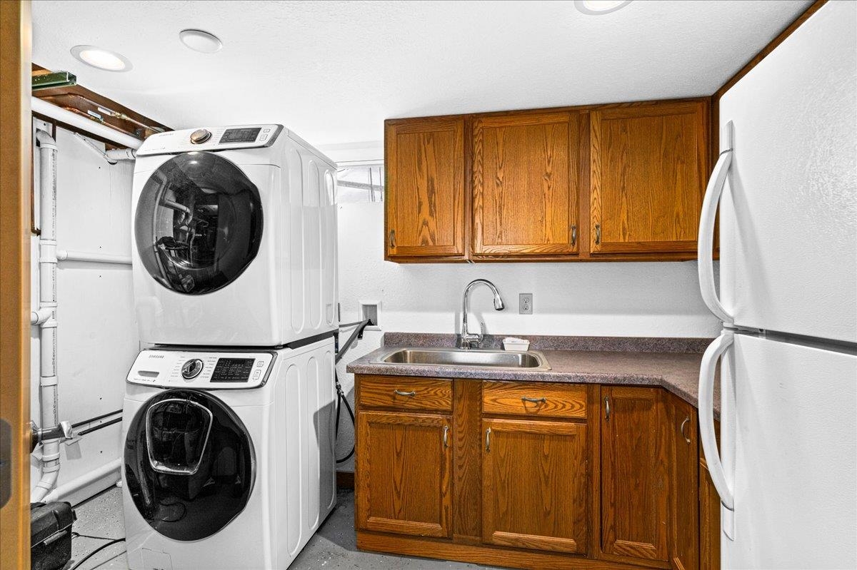 4016 West Arrowhead Road Duluth, MN 55811 - Photo 21 of 39 Laundry area featuring stacked washer / dryer and cabinet space