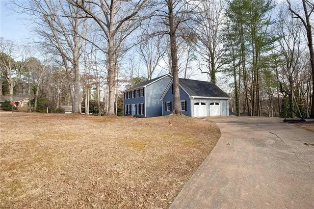 a view of a hallway with wooden floor and entryway