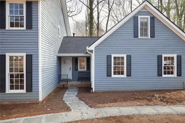 a view of a dining room with furniture wooden floor and chandelier