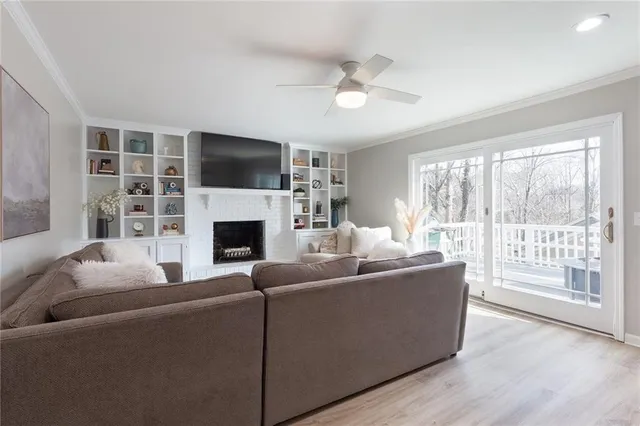 a view of a dining room with furniture a chandelier and wooden floor