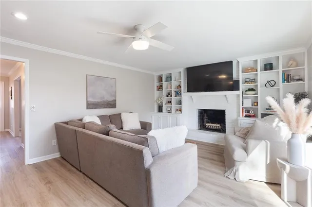 a kitchen with stainless steel appliances granite countertop a stove a sink dishwasher and a white countertops with wooden floor