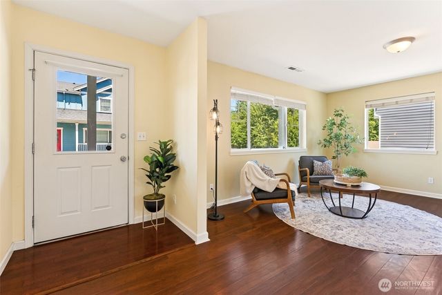 a living room with furniture window and wooden floor