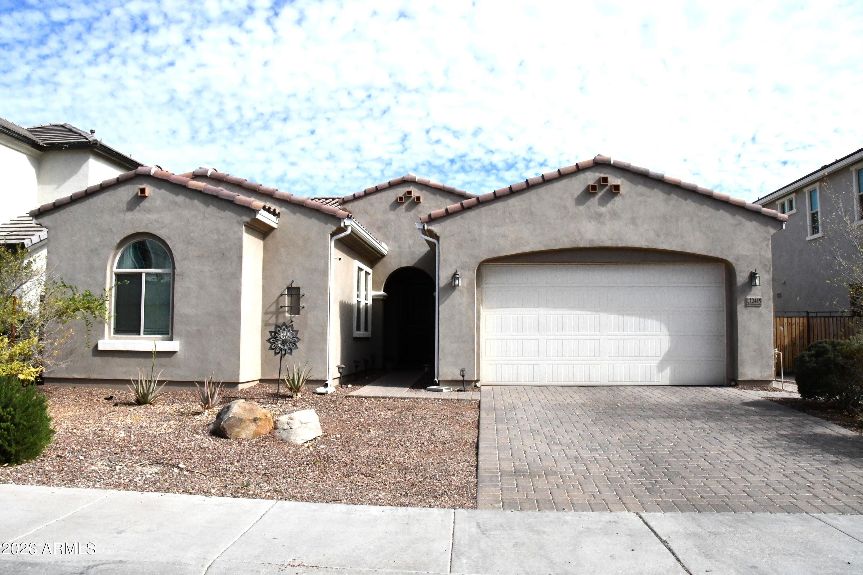 a front view of a house with a yard and garage