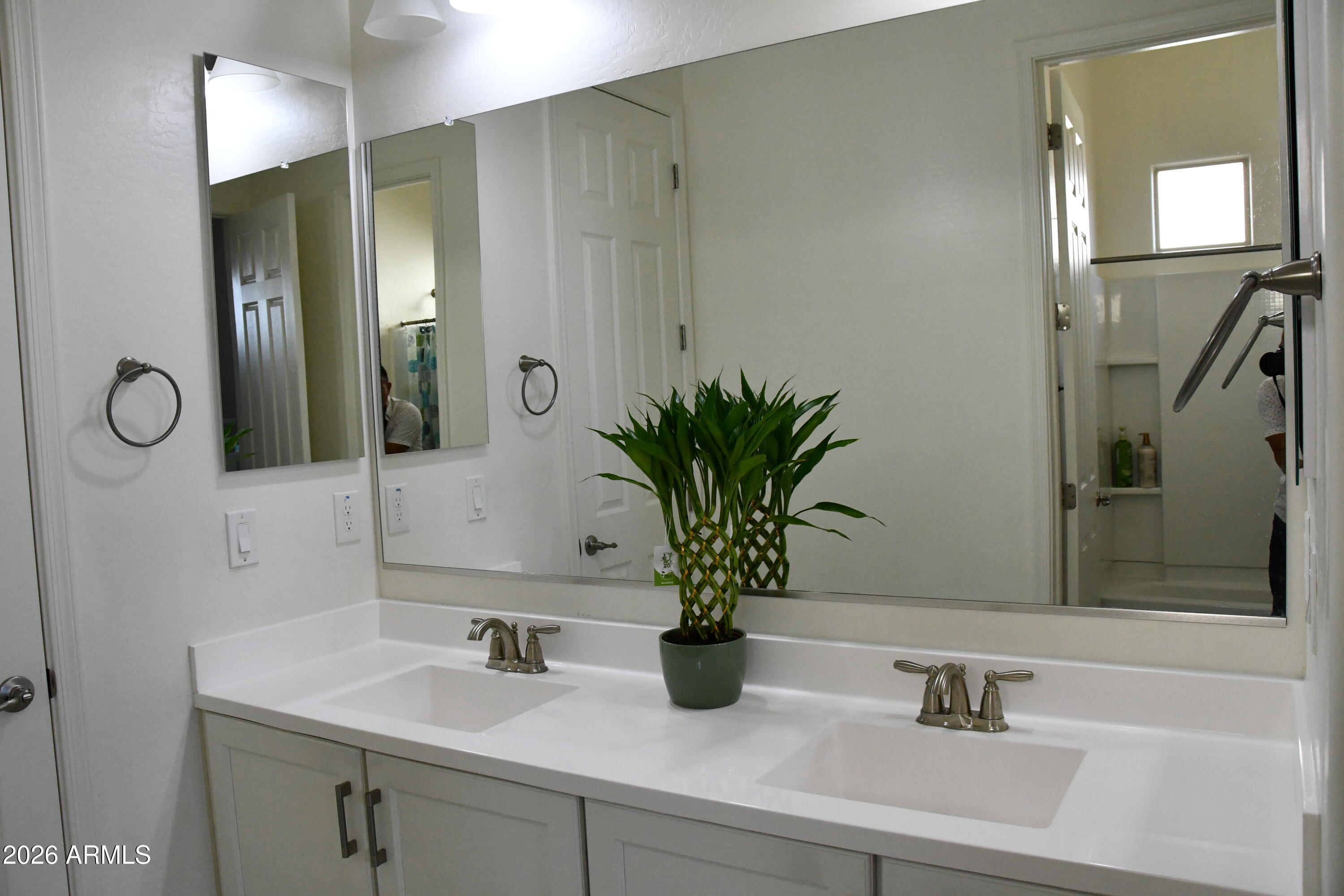 22419 97th Lane Peoria, AZ 85383 - Photo 11 of 22 a bathroom with a sink and a mirror