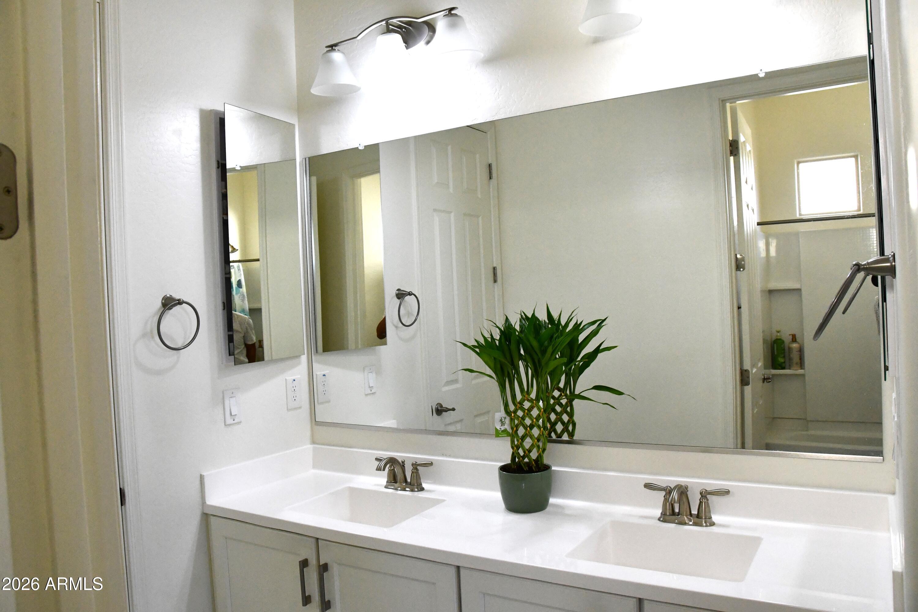 22419 97th Lane Peoria, AZ 85383 - Photo 12 of 22 a bathroom with a sink and a mirror