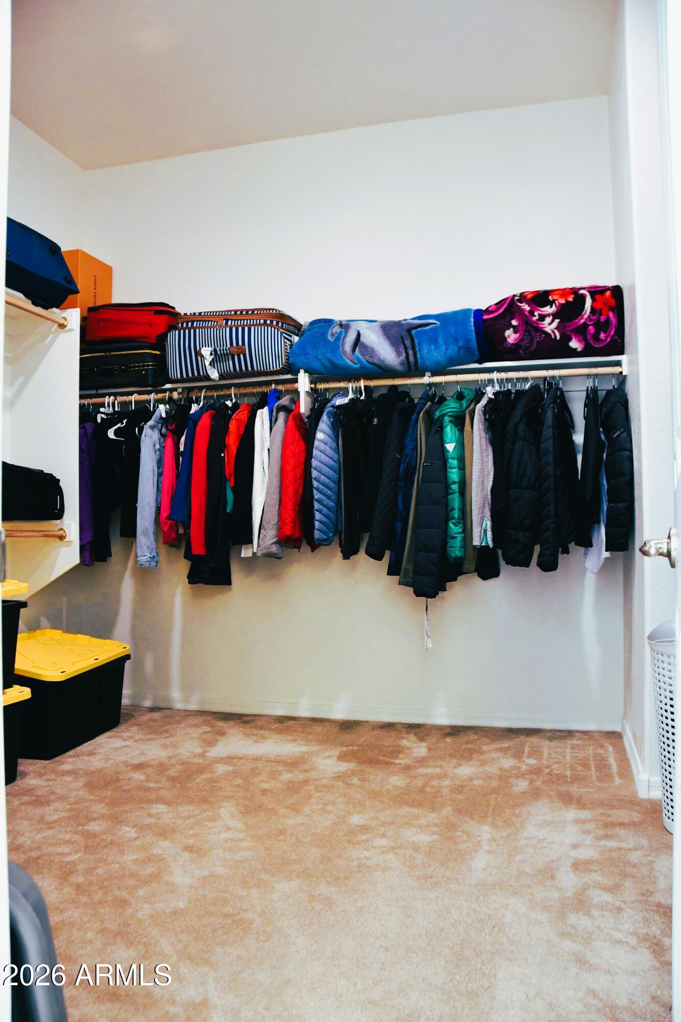 22419 97th Lane Peoria, AZ 85383 - Photo 13 of 22 a view of walk in closet with clothes and shoes