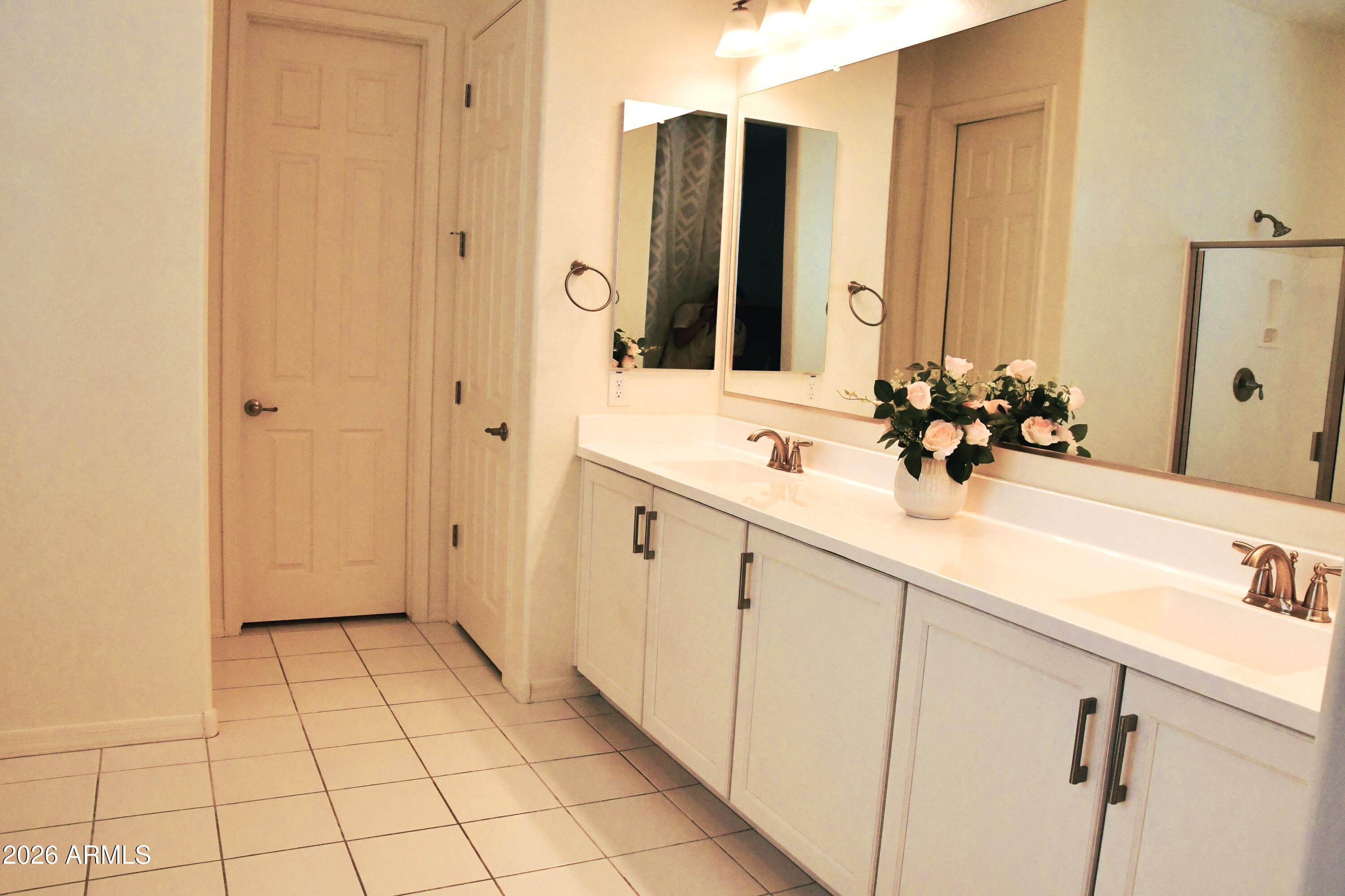 22419 97th Lane Peoria, AZ 85383 - Photo 14 of 22 a bathroom with a sink and a mirror