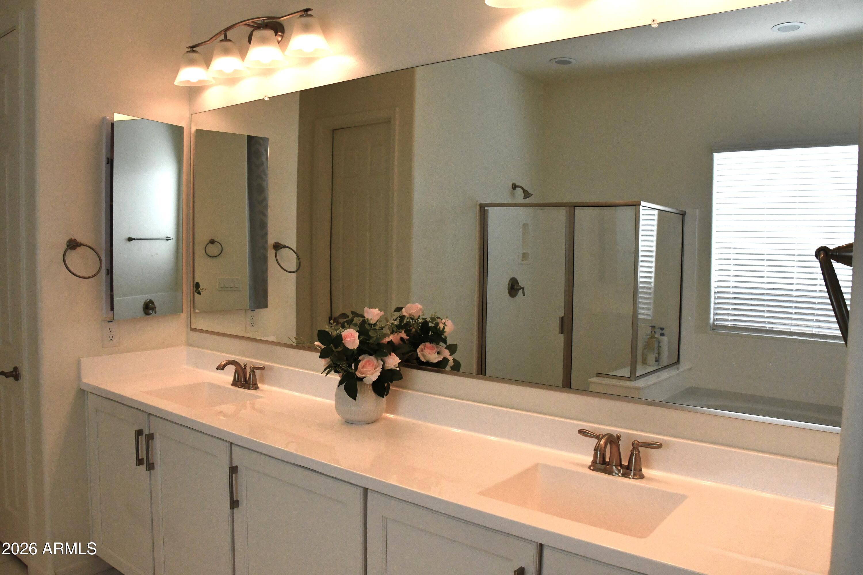 22419 97th Lane Peoria, AZ 85383 - Photo 15 of 22 a bathroom with a sink and a mirror