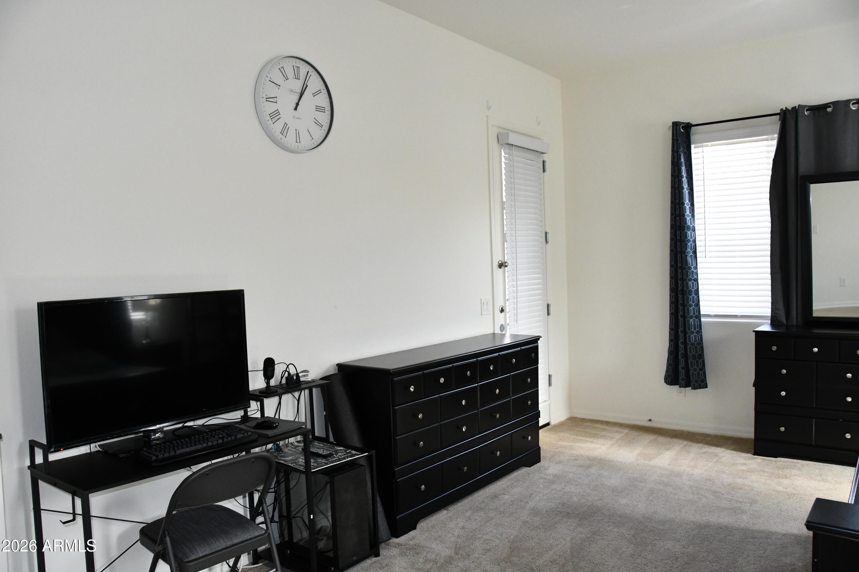 22419 97th Lane Peoria, AZ 85383 - Photo 17 of 22 a view of a livingroom with furniture and a flat screen tv