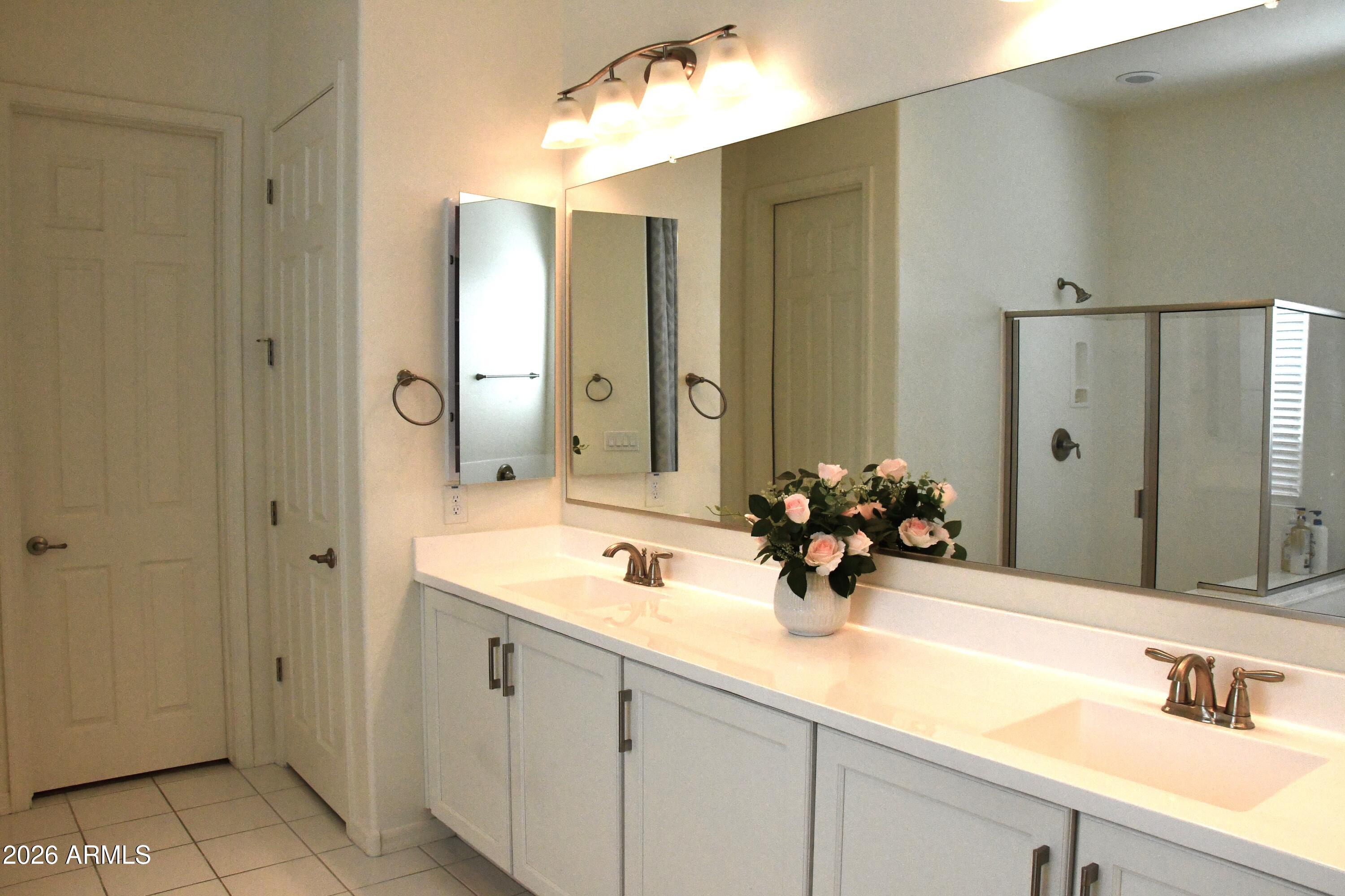 22419 97th Lane Peoria, AZ 85383 - Photo 18 of 22 a bathroom with a double vanity sink and a mirror