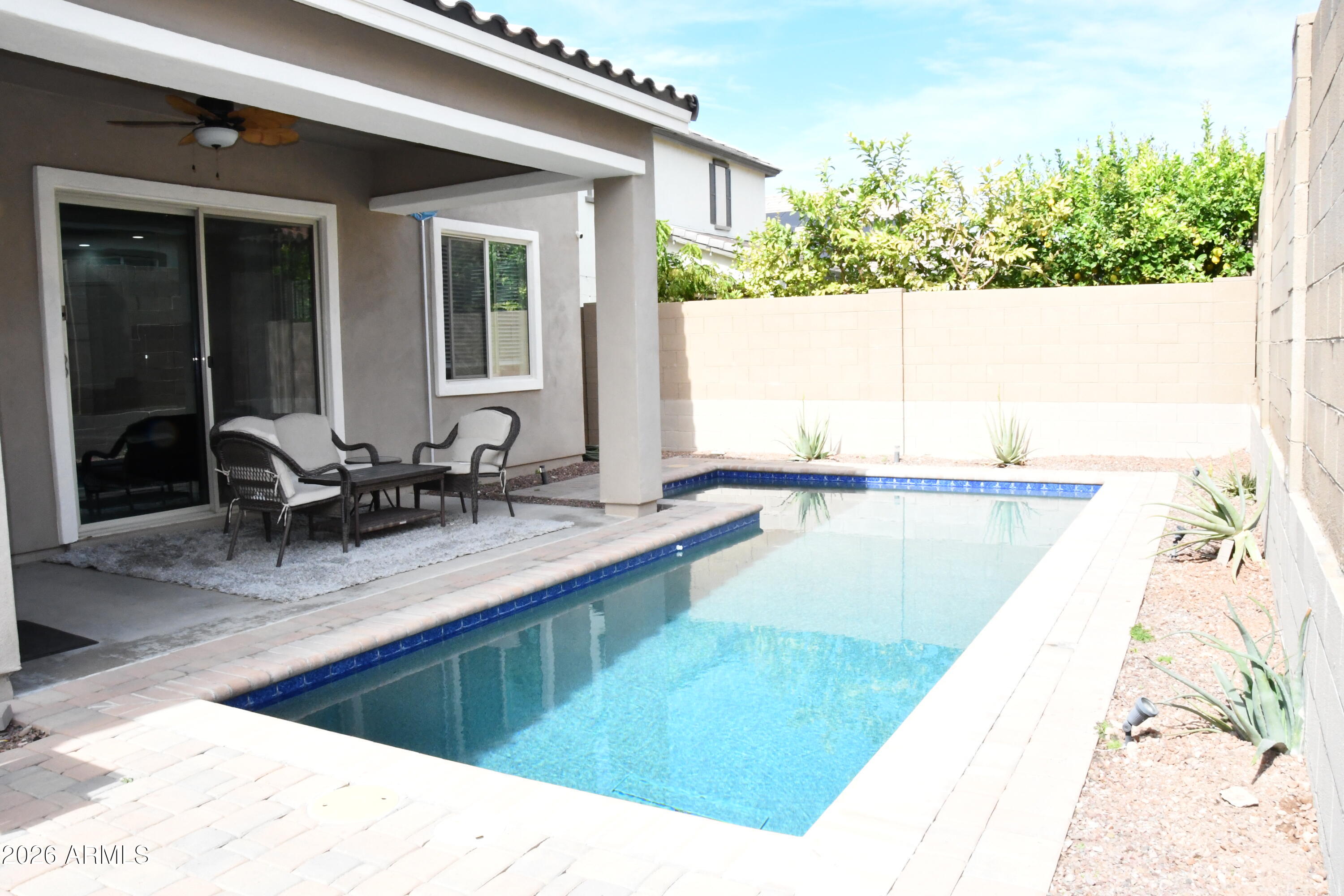 22419 97th Lane Peoria, AZ 85383 - Photo 20 of 22 a view of a swimming pool with outdoor seating