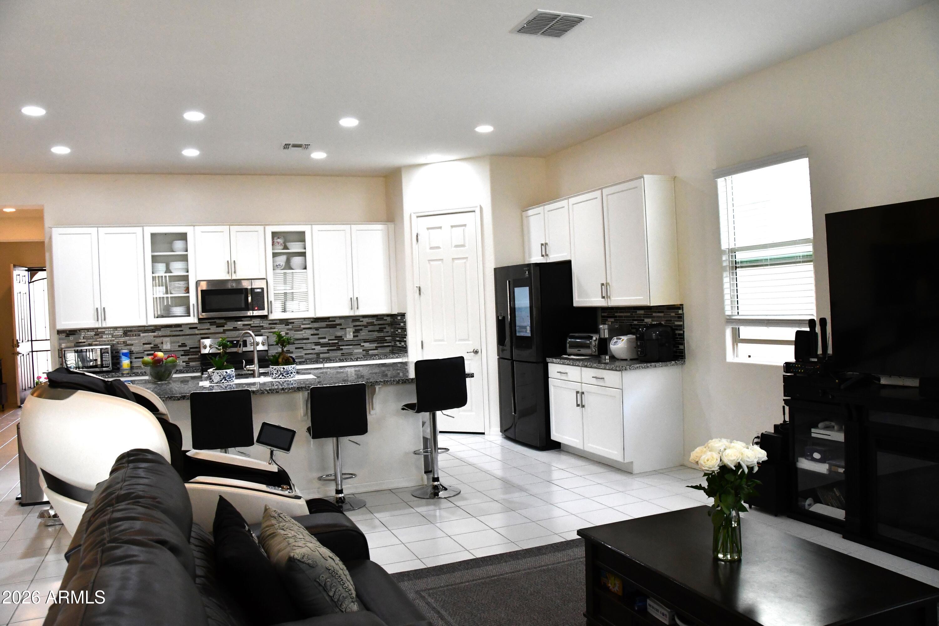 22419 97th Lane Peoria, AZ 85383 - Photo 2 of 22 a kitchen with a sink stove and refrigerator